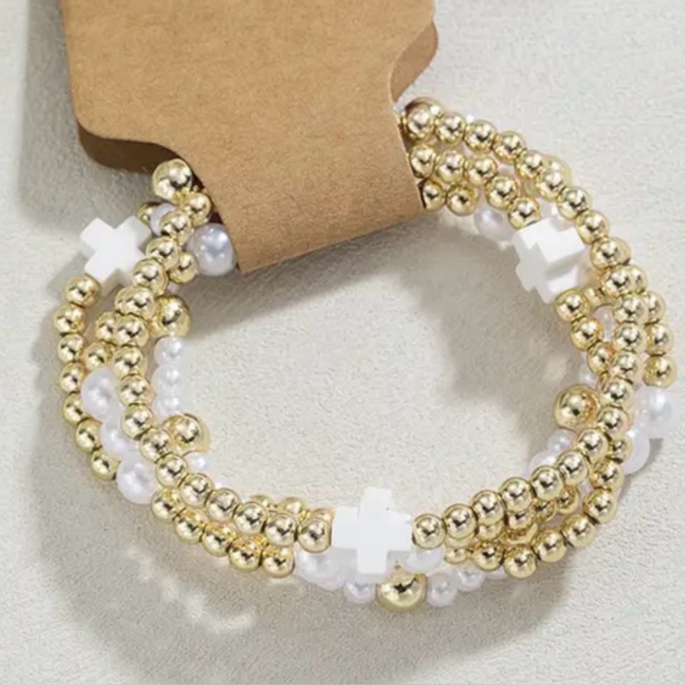 Set of 4 stretch bracelets.gold and white pearl and cross